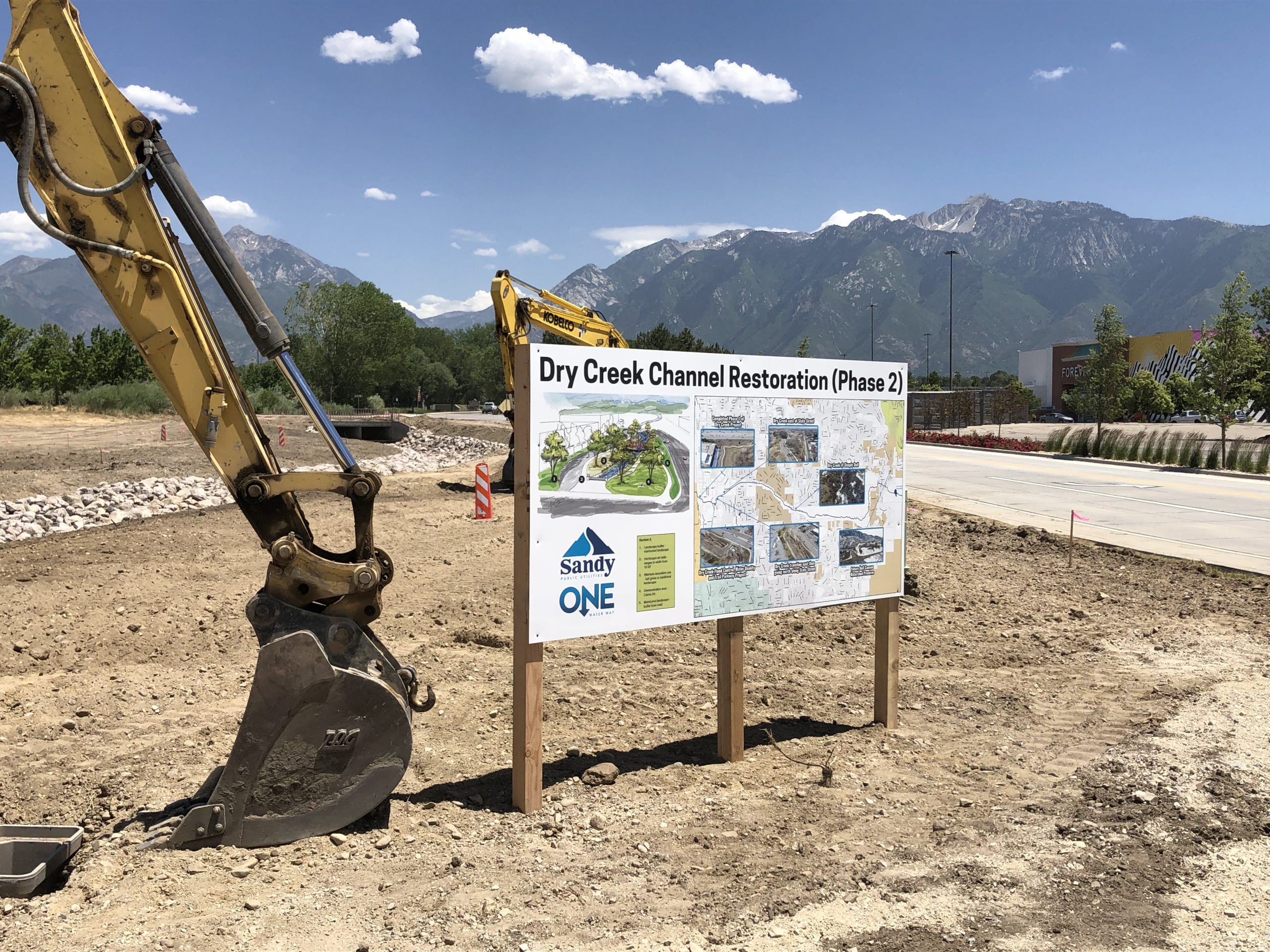 Dry Creek Channel construction site with sign showing restoration plan.